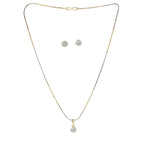 Gold necklace with a pendant and matching earrings on a white background