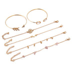 Set of gold necklaces with various pendants on a white background