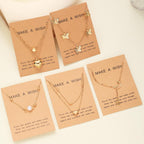 Set of gold necklaces on 'Make a Wish' cards with decorative elements.