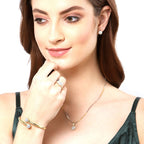 Woman wearing gold jewelry including a necklace, bracelet, and ring on a white background