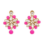 Pair of earrings with pink beads and gold accents on a white background