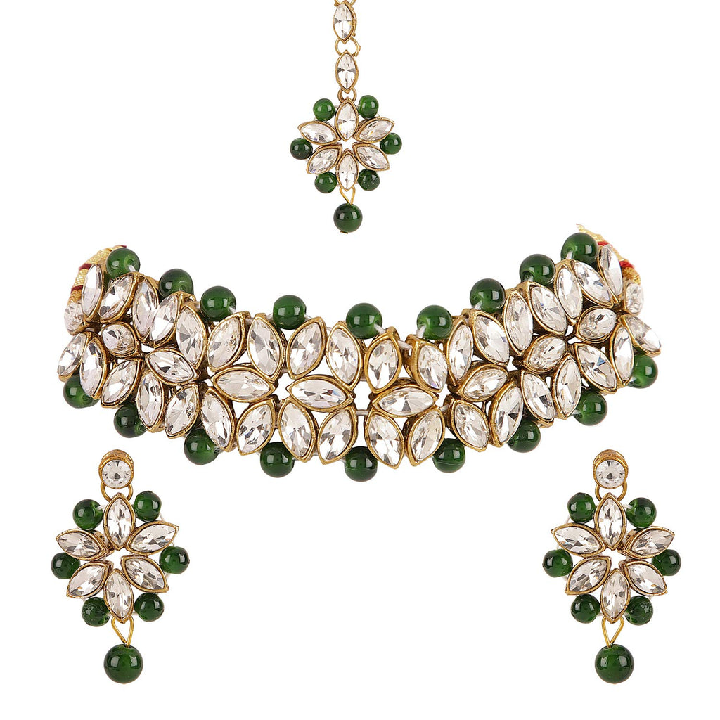 Jewelry set with necklace, earrings, and maang tikka on a white background