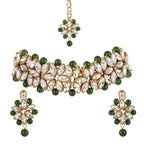 Jewelry set with necklace, earrings, and maang tikka on a white background