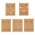 Five gold necklaces with various pendants on brown cards with 'Make a Wish' text.