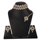 Jewelry set with necklace, earrings, and ring on a black stand against a white background