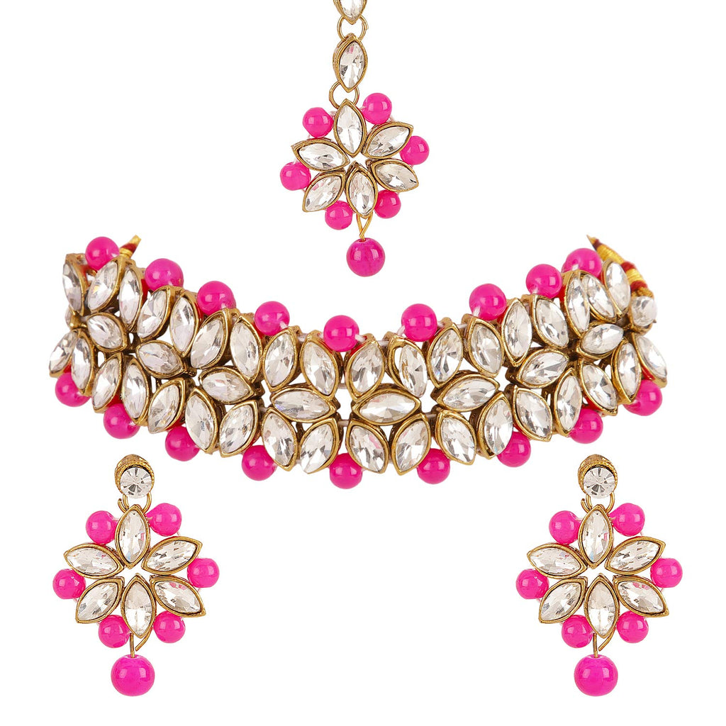 Jewelry set with pink and white stones on a white background