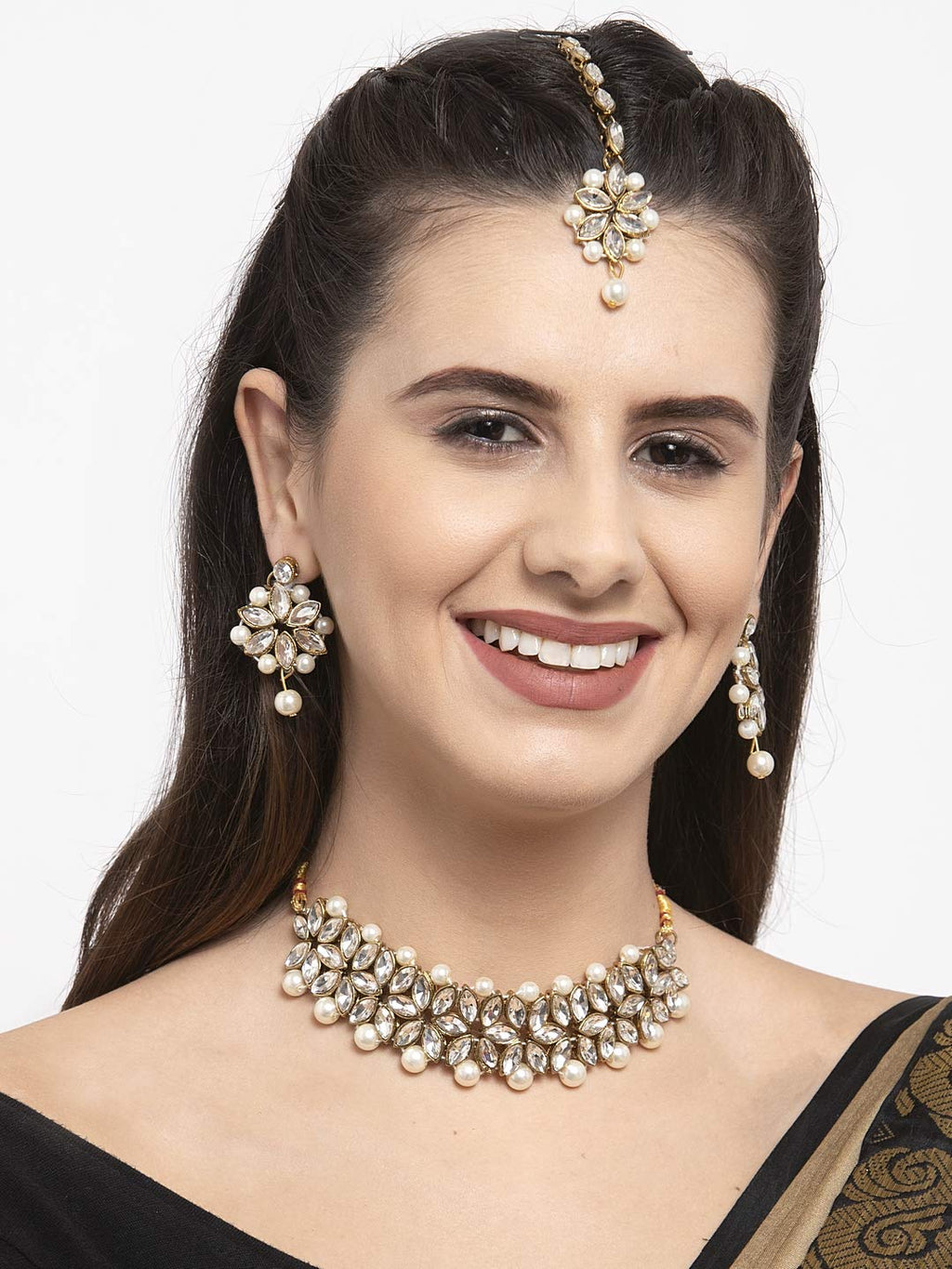 Woman wearing a pearl necklace and earrings on a white background