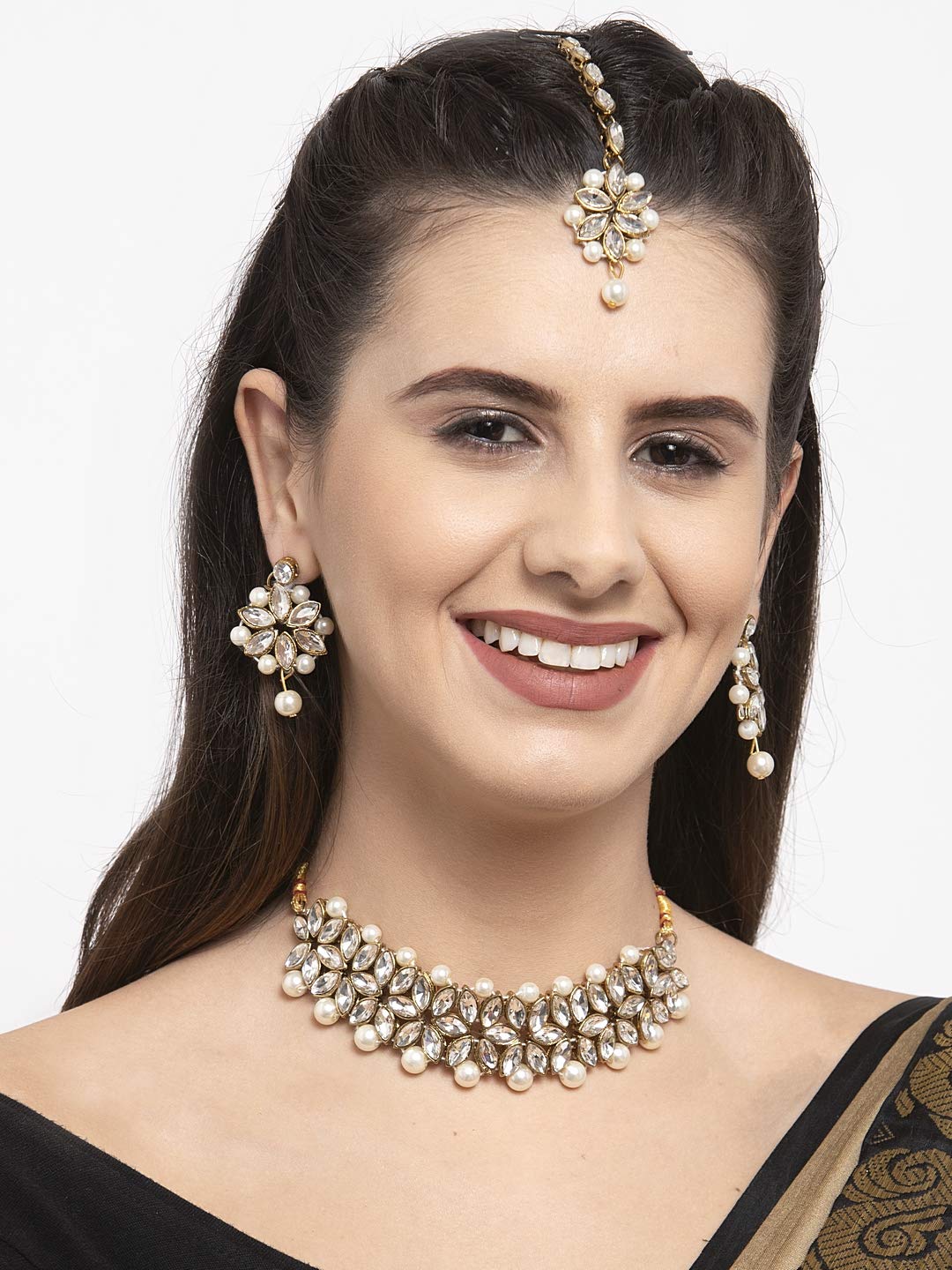 Woman wearing a pearl necklace and earrings on a white background
