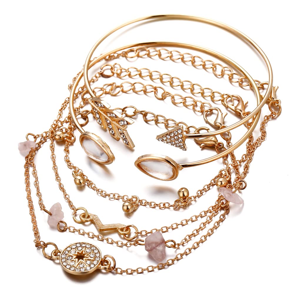 Gold jewelry set with bracelets and necklaces on a white background