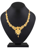 Gold necklace on a black mannequin bust