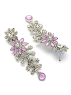 Pair of floral earrings with pink gemstones on a white background