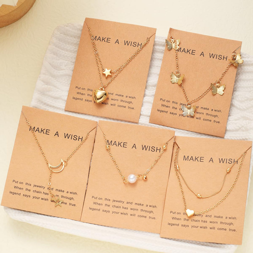 Set of gold necklaces on 'Make a Wish' cards with a neutral background