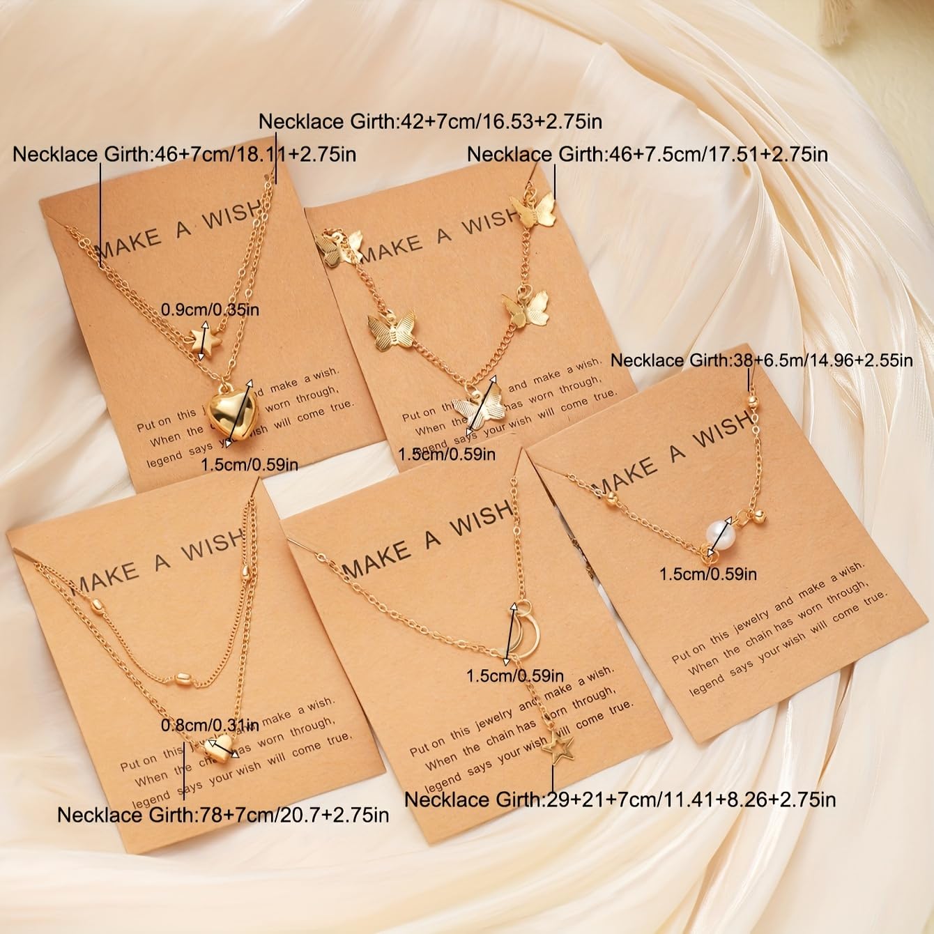 Gold necklaces on 'Make a Wish' cards with measurements