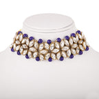 Elegant necklace with purple and clear stones on a mannequin bust against a white background