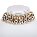 Elegant choker necklace with pearls and crystals on a white stand