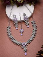 Jewelry set with necklace and earrings on a brown background